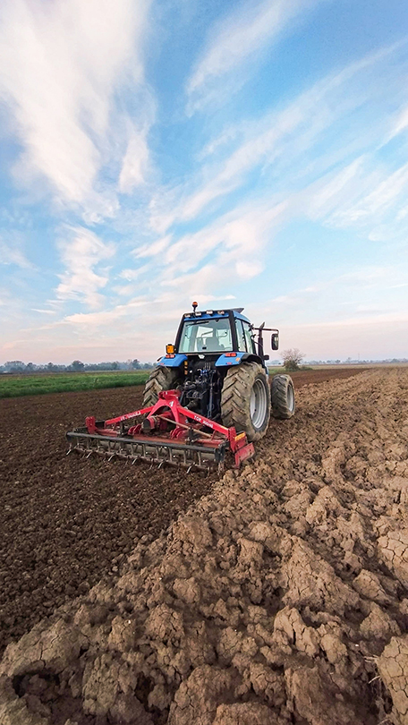 Soil preparation with tractor and disc harrow in open field